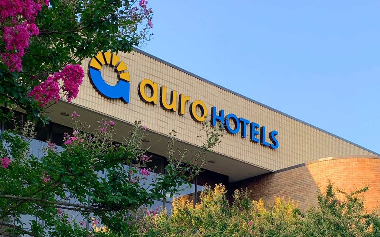 Auro Hotels headquarters exterior sign with logo